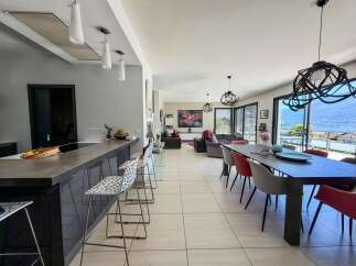Experience modern living in this spacious open-plan home, featuring a sleek kitchen island with bar seating and a separate dining area perfect for entertaining.