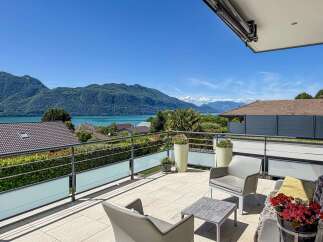 Experience breathtaking lake and mountain views from this stunning balcony, perfect for enjoying your morning coffee or evening sunset.