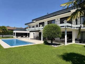 Experience luxury living in this modern villa featuring a stunning swimming pool and expansive outdoor entertainment areas.