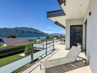 Enjoy breathtaking lake and mountain views from this stunning modern balcony.