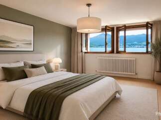 Experience serene living in this beautifully appointed bedroom, featuring a plush king-size bed and a large window offering breathtaking lake and mountain views.