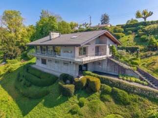 Discover this stunning modern home nestled on a lush, tiered hillside, offering breathtaking views and exceptional privacy.