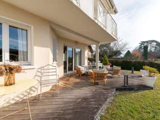 Enjoy outdoor living on this spacious wooden deck, perfect for entertaining or relaxing.