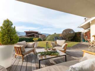 Enjoy outdoor living on this spacious wooden deck, perfect for entertaining or relaxing.
