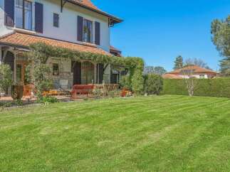 Enjoy the beautiful outdoors with this stunning property featuring a meticulously manicured lawn perfect for recreation and relaxation.