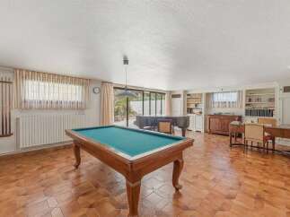 This spacious room offers a perfect blend of leisure and study, featuring a classic billiard table and a grand piano for entertainment.