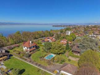 Experience luxurious living in this stunning property featuring a private swimming pool and expansive green lawns, perfect for relaxation and entertainment.