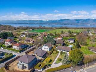 Discover this stunning property offering breathtaking views of a serene lake and majestic snow-capped mountains.