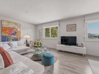 Experience modern living in this bright and airy living room, featuring a spacious sectional sofa perfect for relaxation and entertaining.