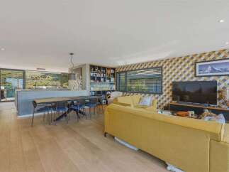 Experience modern living in this open-concept home featuring a spacious dining area with a sleek table and chairs, perfect for family gatherings.