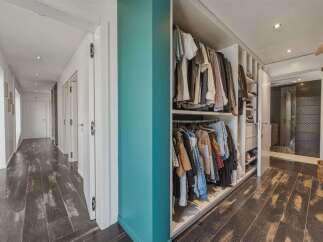 Discover this spacious hallway featuring a built-in closet with ample storage for your wardrobe.