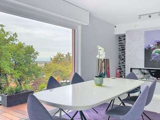 Experience modern dining with a stunning panoramic view from this elegant dining room.