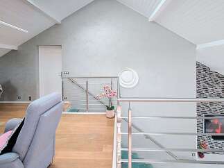 Discover this modern living space featuring a stylish open-plan layout with a sleek staircase and contemporary finishes.