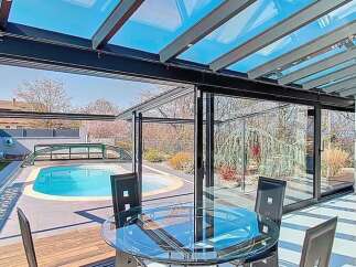 Experience luxury living with this stunning property featuring a retractable glass roof enclosure, perfect for enjoying the outdoors year-round.