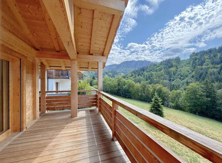 Experience breathtaking mountain views from this charming wooden balcony, perfect for enjoying your morning coffee or evening relaxation.