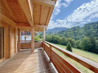 Experience breathtaking mountain views from this charming wooden balcony, perfect for enjoying your morning coffee or evening relaxation.