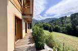 Experience breathtaking mountain views from this stunning property, featuring a spacious wooden deck perfect for outdoor living.