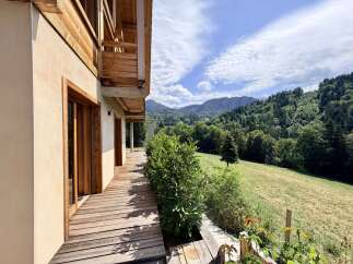 Experience breathtaking mountain views from this stunning property, featuring a spacious wooden deck perfect for outdoor living.