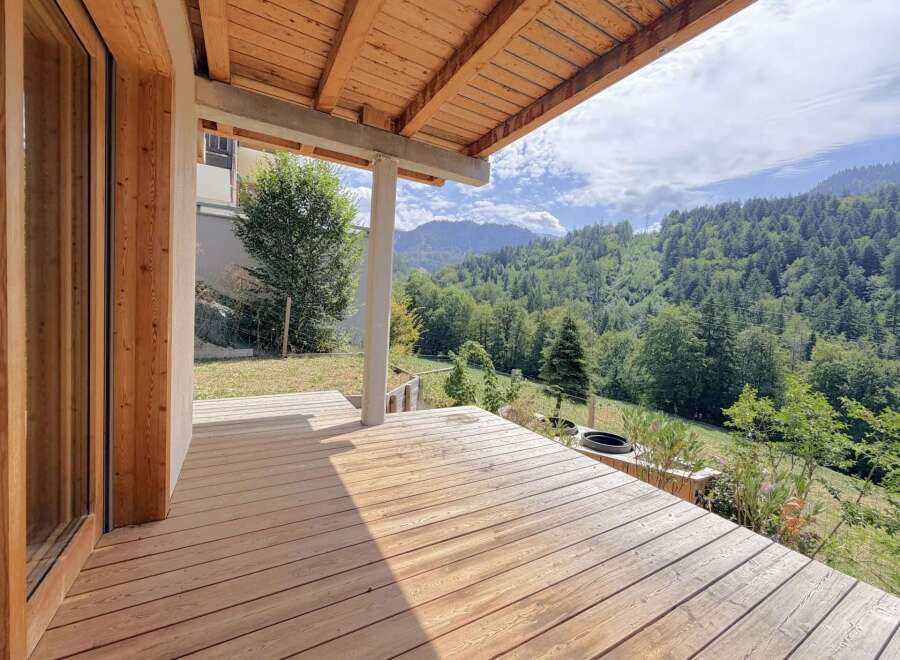 Experience breathtaking mountain views from this stunning wooden deck, perfect for outdoor living.