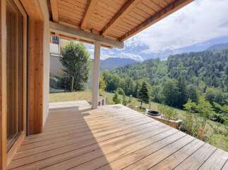 Experience breathtaking mountain views from this stunning wooden deck, perfect for outdoor living.