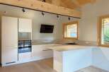 Discover this modern kitchen featuring sleek white cabinetry and integrated appliances, perfect for a contemporary home.