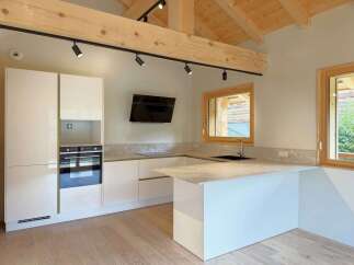 Discover this modern kitchen featuring sleek white cabinetry and integrated appliances, perfect for a contemporary home.