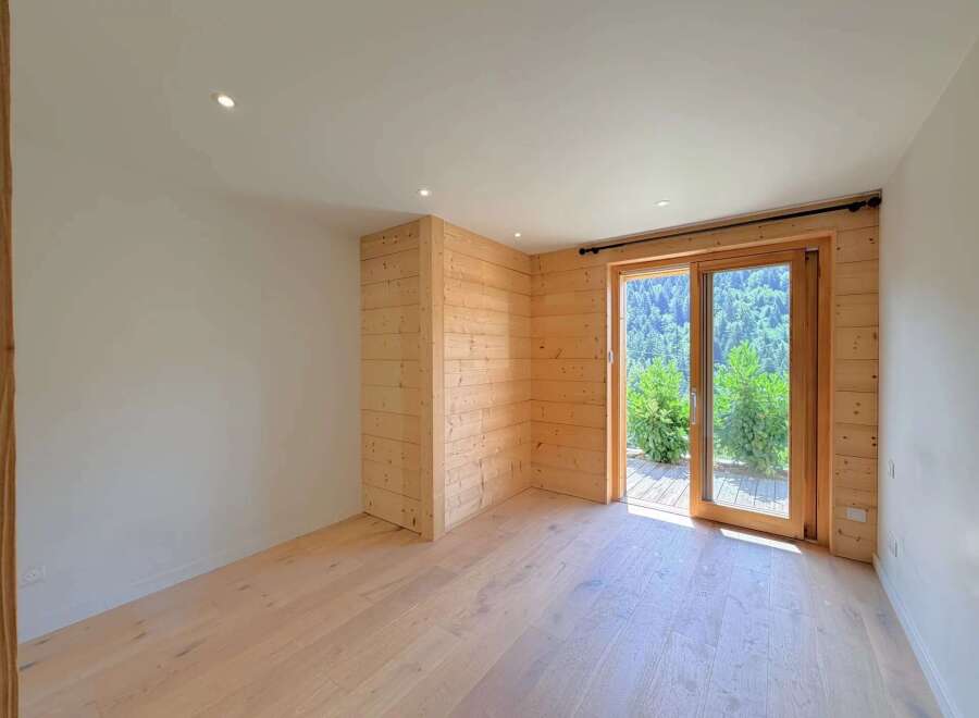 Experience modern living with this beautifully appointed room featuring natural wood paneling and a bright, airy atmosphere.