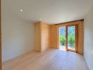 Experience modern living with this beautifully appointed room featuring natural wood paneling and a bright, airy atmosphere.