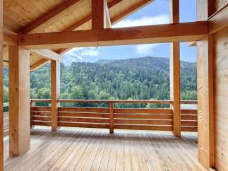 Experience breathtaking mountain views from this stunning wooden deck, perfect for enjoying the serene natural surroundings.