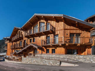 Experience the charm of this stunning wooden chalet, featuring multiple balconies perfect for enjoying mountain views.