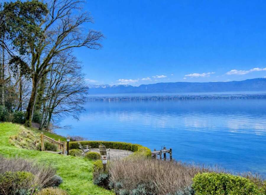 Experience breathtaking lakefront living with this stunning property offering panoramic views of the water and distant mountains.