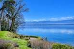 Experience breathtaking lakefront living with this stunning property offering panoramic views of the water and distant mountains.