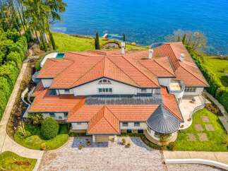 Experience luxury living with this stunning waterfront estate, boasting panoramic ocean views and direct access to the water.