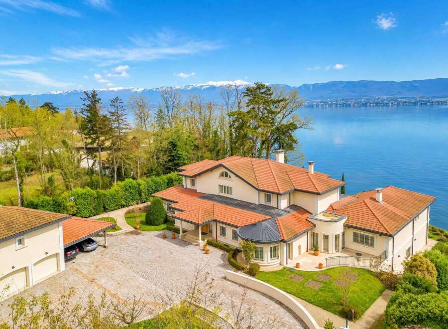 Experience luxury living with this stunning villa offering breathtaking panoramic views of the lake and snow-capped mountains.