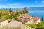 Experience luxury living with this stunning villa offering breathtaking panoramic views of the lake and snow-capped mountains.