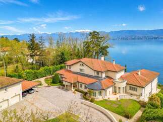Experience luxury living with this stunning villa offering breathtaking panoramic views of the lake and snow-capped mountains.