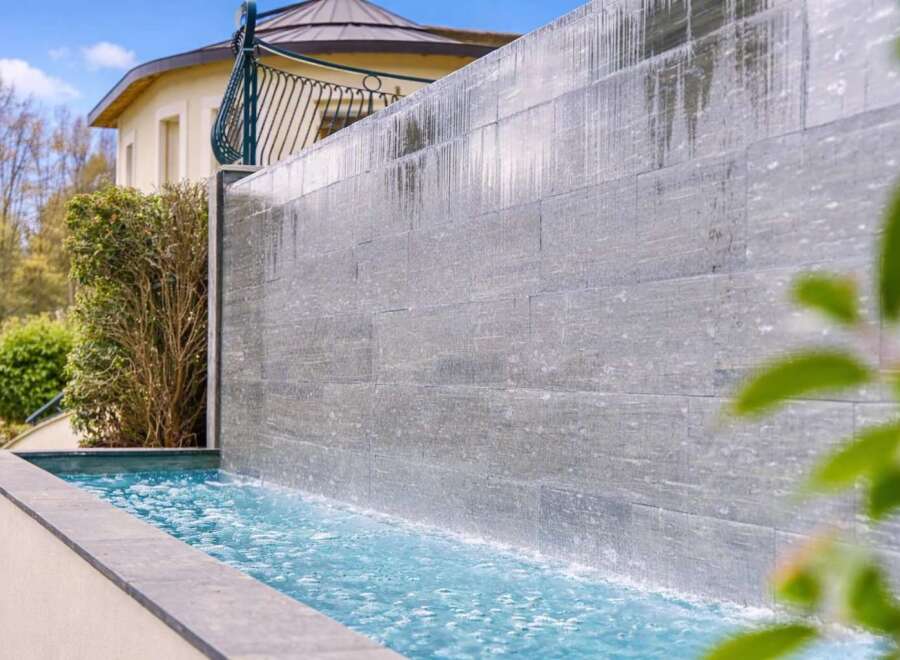 Experience luxury living with this stunning water feature, perfect for creating a serene ambiance in your backyard.