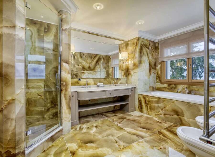 Indulge in luxury with this stunning bathroom featuring exquisite onyx tilework throughout.
