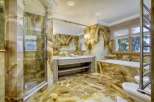 Indulge in luxury with this stunning bathroom featuring exquisite onyx tilework throughout.
