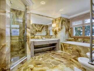 Indulge in luxury with this stunning bathroom featuring exquisite onyx tilework throughout.