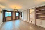 Experience luxury living in this spacious room featuring elegant floor-to-ceiling mirrored wardrobes and built-in shelving.