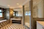Experience luxury in this stunning bathroom featuring a spacious soaking tub and a separate glass-enclosed shower.