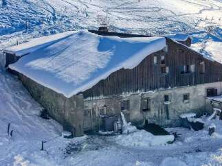 Experience the charm of this rustic mountain property, nestled in a serene, snow-covered landscape.
