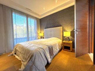 Experience comfort and style in this beautifully appointed bedroom, featuring a plush king-sized bed with a sophisticated upholstered headboard.