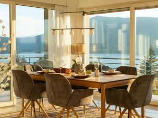 Enjoy breathtaking lake and mountain views from this elegant dining room, perfect for hosting gatherings.
