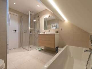 Experience modern comfort in this beautifully appointed bathroom, featuring a spacious walk-in shower and a luxurious bathtub perfect for relaxation.