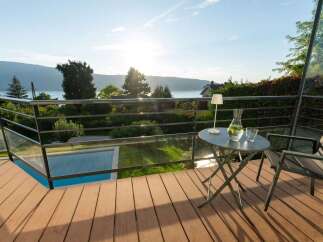 Enjoy breathtaking lake and mountain views from this stunning balcony, complete with a charming bistro set for two.