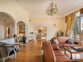 Step into this luxurious living room, featuring elegant leather sofas and a stunning chandelier.