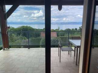 Enjoy breathtaking lake views from this stunning balcony, perfect for al fresco dining or morning coffee.