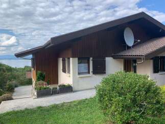 Discover this charming property with a beautiful wooden exterior and a large satellite dish.
